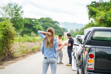 Back view of woman waiting her husband with car slide after car accidents on road side. Traffic accident insurance concept