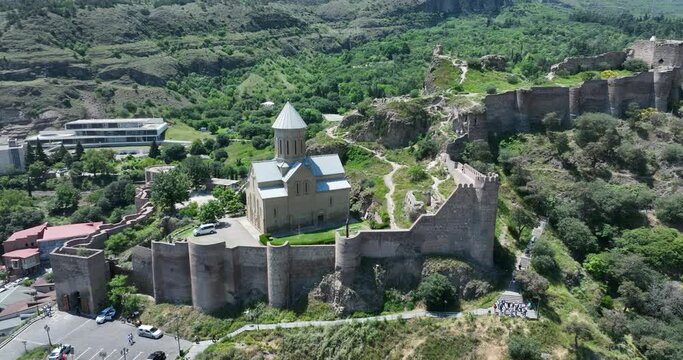 Aerial view of Tbilisi old town buildings and Narikala fortress landmark on hill. Georgia