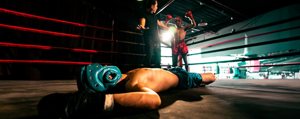 Boxing referee intervene, halting the fight to check fallen competitor after knock out. Referee...