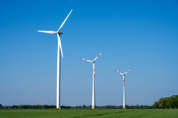 Three modern wind turbines seen in Germany