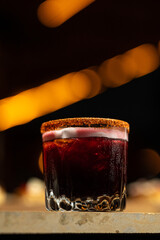 Alcoholic beverage with a dark background and lights. 