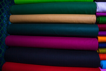 Artistic variety shade tone colors Textile Fabrics stacked on retail Shop Shelf to sale