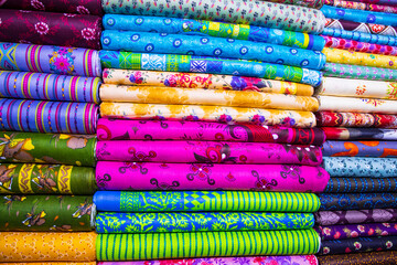 Artistic variety shade tone textile printed colors Fabrics stacked on retail Shop Shelf to sale