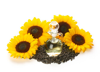 Sunflowers, seeds and decanter with oil on white background