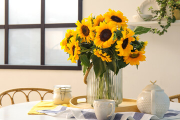 Vase with beautiful sunflowers on dining table, closeup