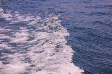 Sea water with waves and reflection in different light. Texture background for design.	