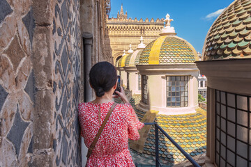 Woman takes a photo with her smartphone on the roof of the Cathedral in Palermo, Sicily © salita2010