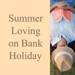 Summer loving on bank holiday text on cream with biracial woman with book and hat lying on grass