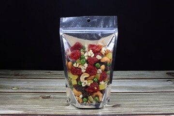 Pile of mixed nut and whole grain serving in the plastic bag. Famous snack product with high...