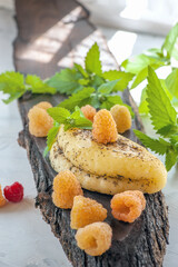 Sliced halloumi cheese with raspberries and strawberries on a wooden board