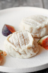 Goat cheese Coulommiers , brie, camembert from Russian farmers. Cheese is served with fruit