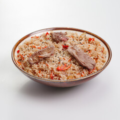 Fried rice with beef and vegetables isolated on white background. Traditional chinese food - fried rice with egg and beef in ceramic bowl.