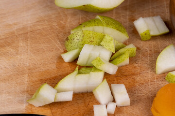 sliced green pear on a wooden board close-up