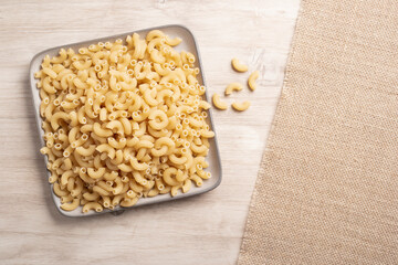 dried pasta on wooden board