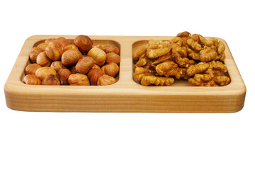 Wooden rack with assorted shelled nuts isolated on white background. Scattering of hazelnuts and walnuts lie in flat wooden bowl. Useful nuts. Preparation for layout.