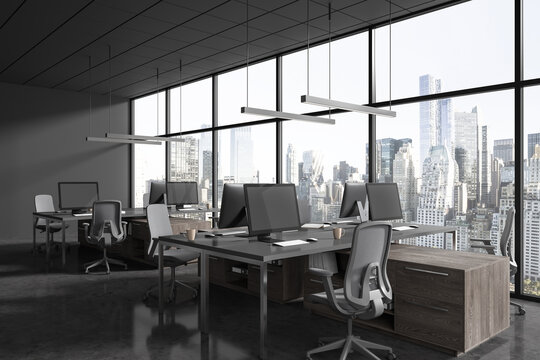 Dark office interior with pc monitors in row, chairs and panoramic window