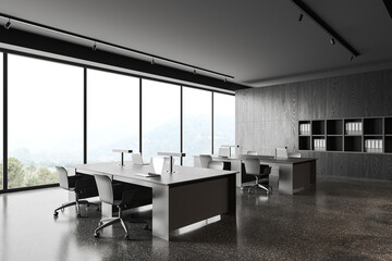 Modern business interior with desk and chairs, laptop and window with shelf