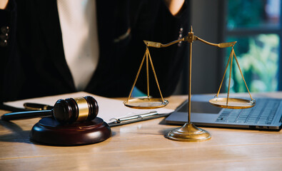 Justice and law concept.Male judge in a courtroom with the gavel, working with, computer and...