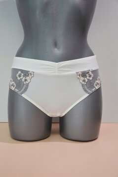 Lingerie. Women's white panties with lace on a mannequin. Beautiful underwear.
