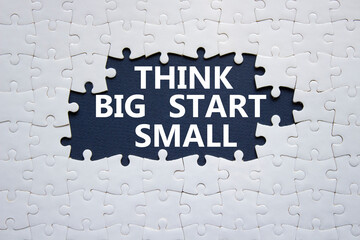 Think big start small symbol. Concept words Think big start small on white puzzle. Beautiful black...