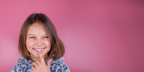 naughty girl, a beautiful girl with a sly expression on a pink background - obrazy, fototapety, plakaty