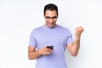 Young caucasian man isolated on white background surprised and sending a message