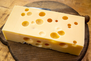 Cheese collection, french hard cheese with holes emmentaler close up