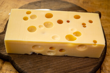 Cheese collection, french hard cheese with holes emmentaler close up