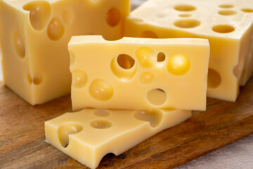 Cheese collection, french hard cheese with holes emmentaler close up