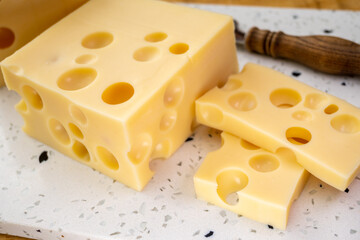 Cheese collection, french hard cheese with holes emmentaler close up