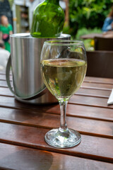 Drinking cold white wine on outdoor terrace, summer vacation, close up