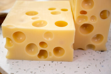 Cheese collection, french hard cheese with holes emmentaler close up