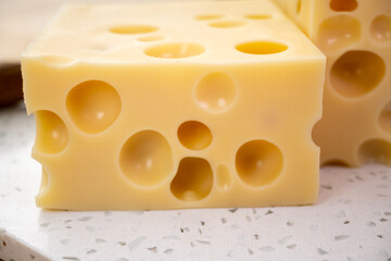 Cheese collection, french hard cheese with holes emmentaler close up