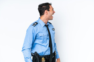 Young police caucasian man isolated on white background laughing in lateral position