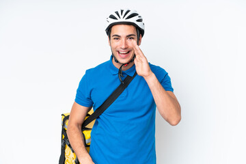 Young caucasian man with thermal backpack isolated on white background shouting with mouth wide open