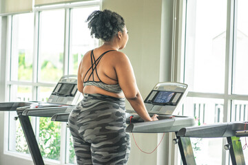 girl plus size women in sports bras walking and running on the treadmill weight loss and exercise...