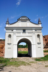 Restored entrance gate and remains of the walls of the Carthusian monastery of 1648-1666 in the town of Bereza, Belarus.