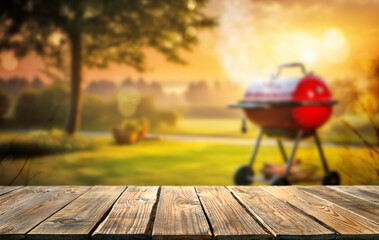 summer time in backyard garden with grill BBQ, wooden table, blurred background - 623716621
