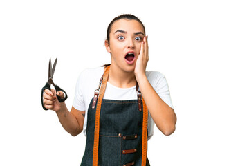 Seamstress woman over isolated chroma key background with surprise and shocked facial expression