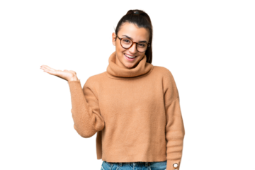 Young beauty woman over isolated chroma key background holding copyspace imaginary on the palm to insert an ad