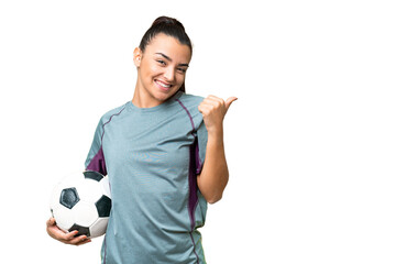 Young football player Woman over isolated chroma key background pointing to the side to present a...