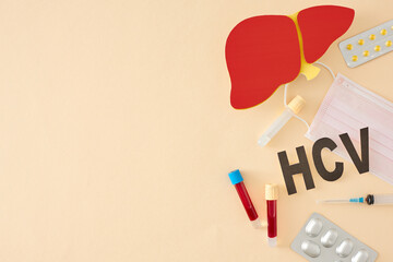 Prevention of hepatitis concept. Top view photo of liver symbol, medical mask, HCV abbreviation,...