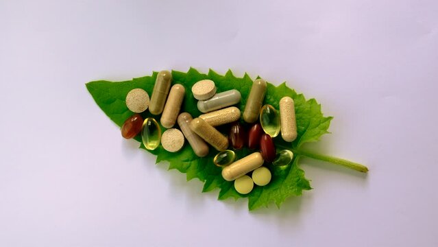 Homeopathy leaves tablets and capsules. Selective focus.