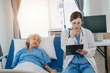 Fototapeta premium professional female doctor treating elderly patients on hospital beds