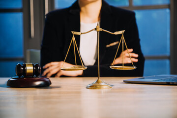 Justice and law concept.Male judge in a courtroom with the gavel, working with, computer and...