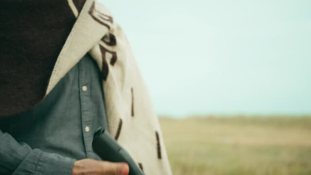 Cowboy swings gun in hand