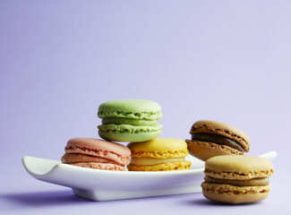 Close up, colorful macarons, light background and copy space.
