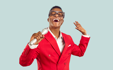 African singer isolated on light background. Stylish ethnic MC or showman taking part in karaoke...