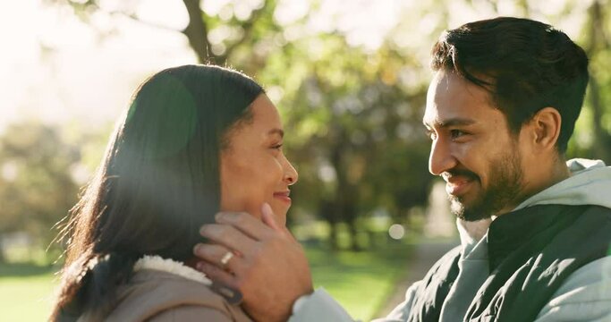 Couple, love and kiss outdoor at a park in nature with care and commitment in marriage. Face of a young man and woman together for happiness, adventure or travel for freedom and relax in a forest