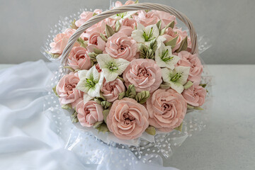 Zephyr bouquet of flowers in a wicker basket on a light background.